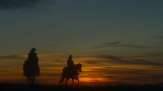 Two silhouettes riding horseback against a sunset in The English
