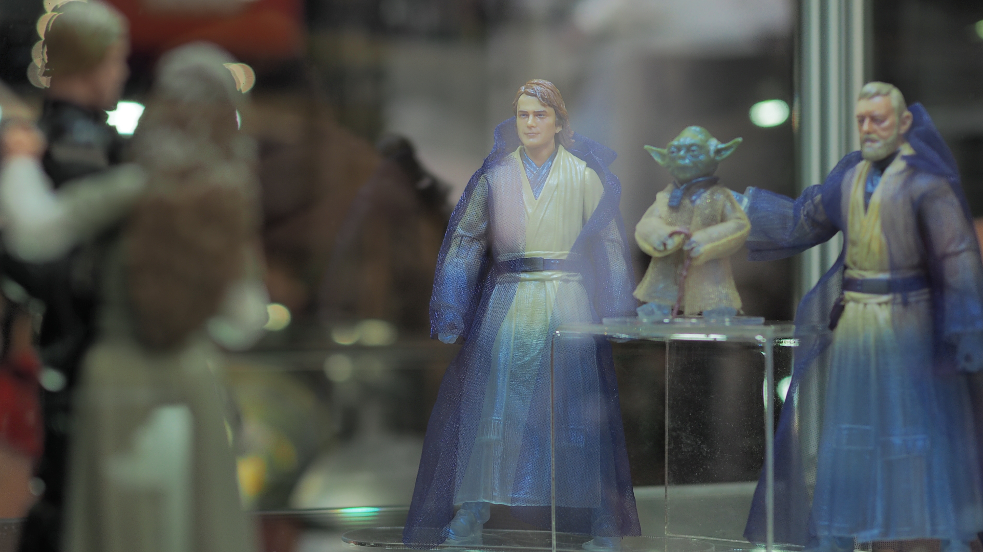 Anakin, Yodi, and Obi-Wan ghost action figures smile at Luke and Leia action figures