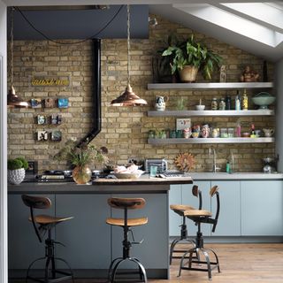 kitchen with wooden flooring and brick wall
