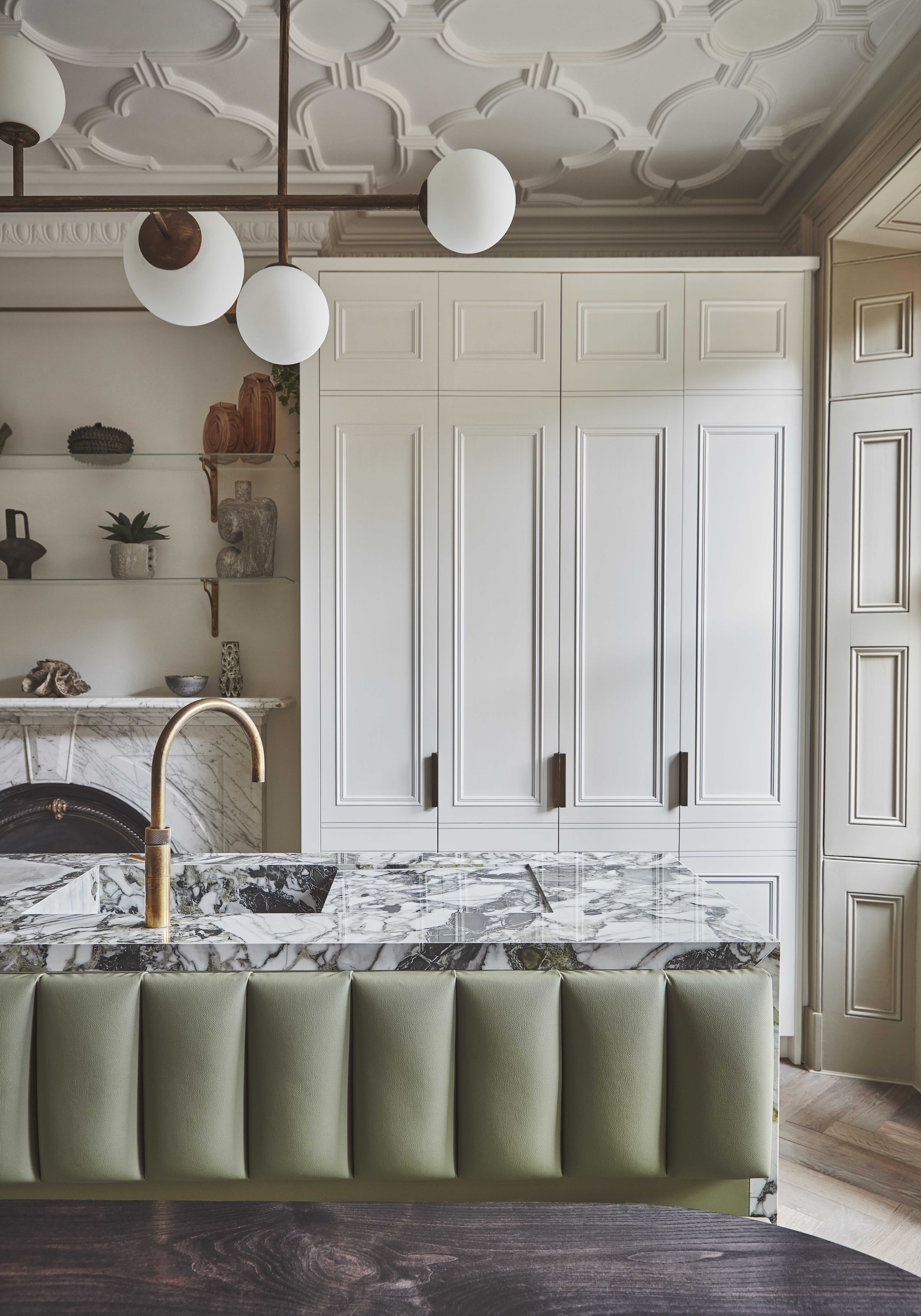 White kitchen with dramatic green marble-style porcelain island