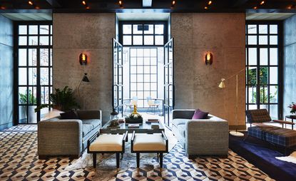 Two sofas with a coffee table in front of a large window