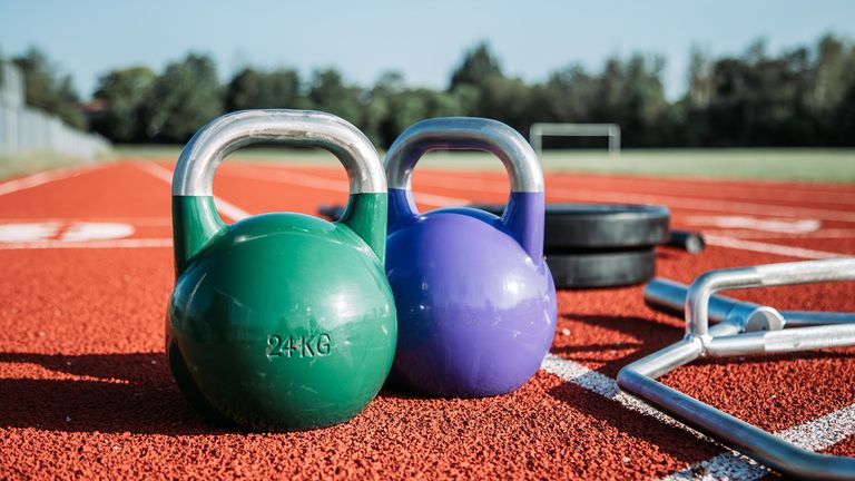 Best kettlebell: a pair of kettlebell weights pictured on a running track
