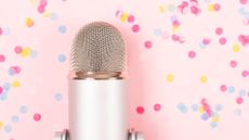 podcast microphone in front of pink background with confetti