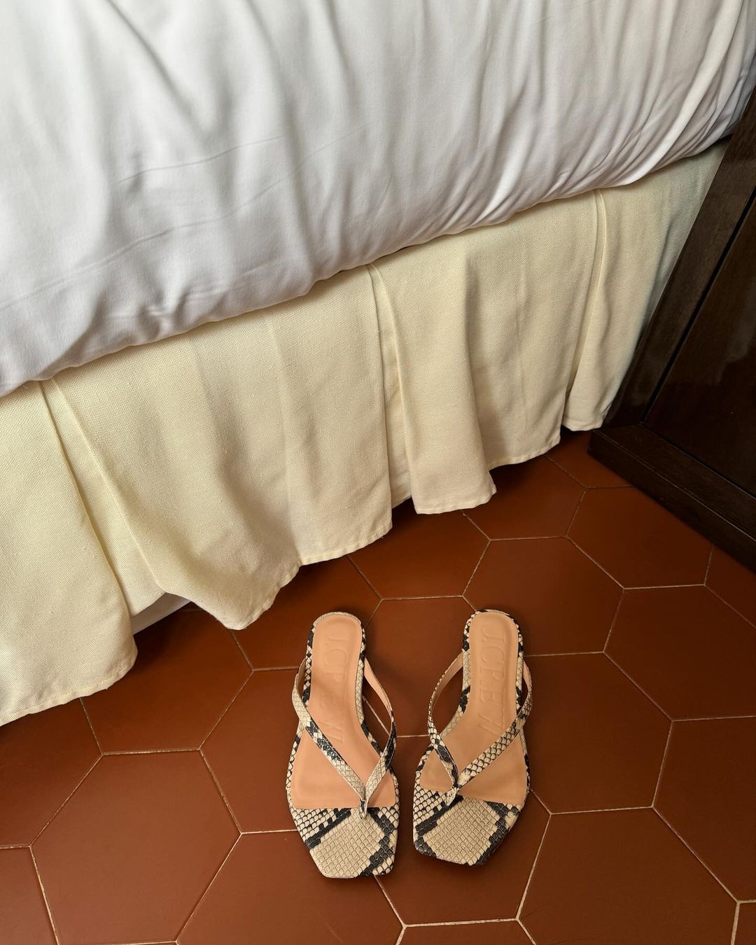 Elegant Summer Style: @monikh shares a snap of snake-print thong sandals on a terracotta tile floor