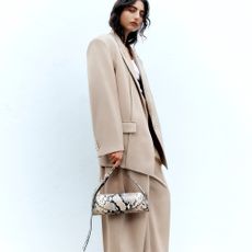 Mondel wearing clothings and accessories sold at net-a-porter