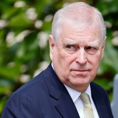 Prince Andrew wearing a blue suit making a serious expression
