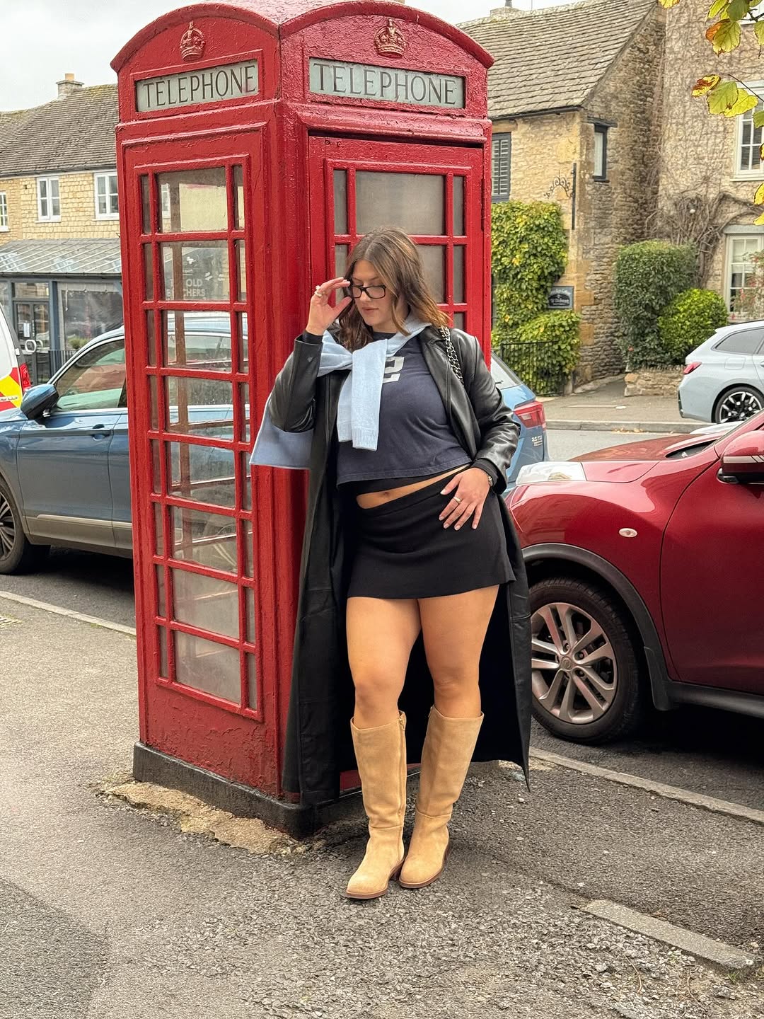 Woman wearing fall boots with skirt outfit 2025.