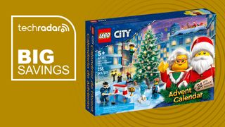 A Lego City advent calendar with Mr. and Mrs. Claus waving on the box, it's next to a sign saying "Big Savings"