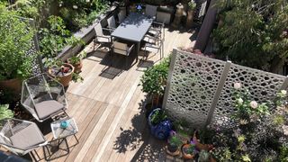 garden decking with decorative cutwork metals screens to zone the garden