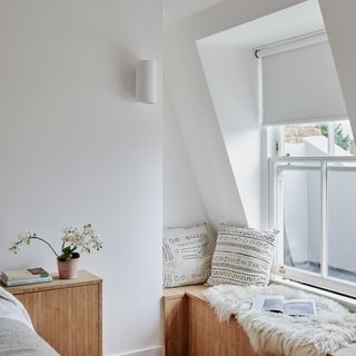 bedroom with window seat roller blind soft upholstery