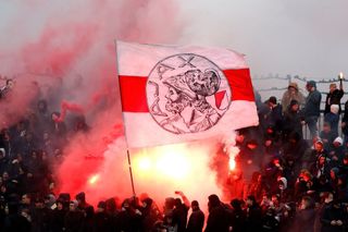 Ajax Amsterdam supporters hold a flag of the club during the public training in Amsterdam, on January 20, 2018, in the run-up to the match against Feyenoord tomorrow.