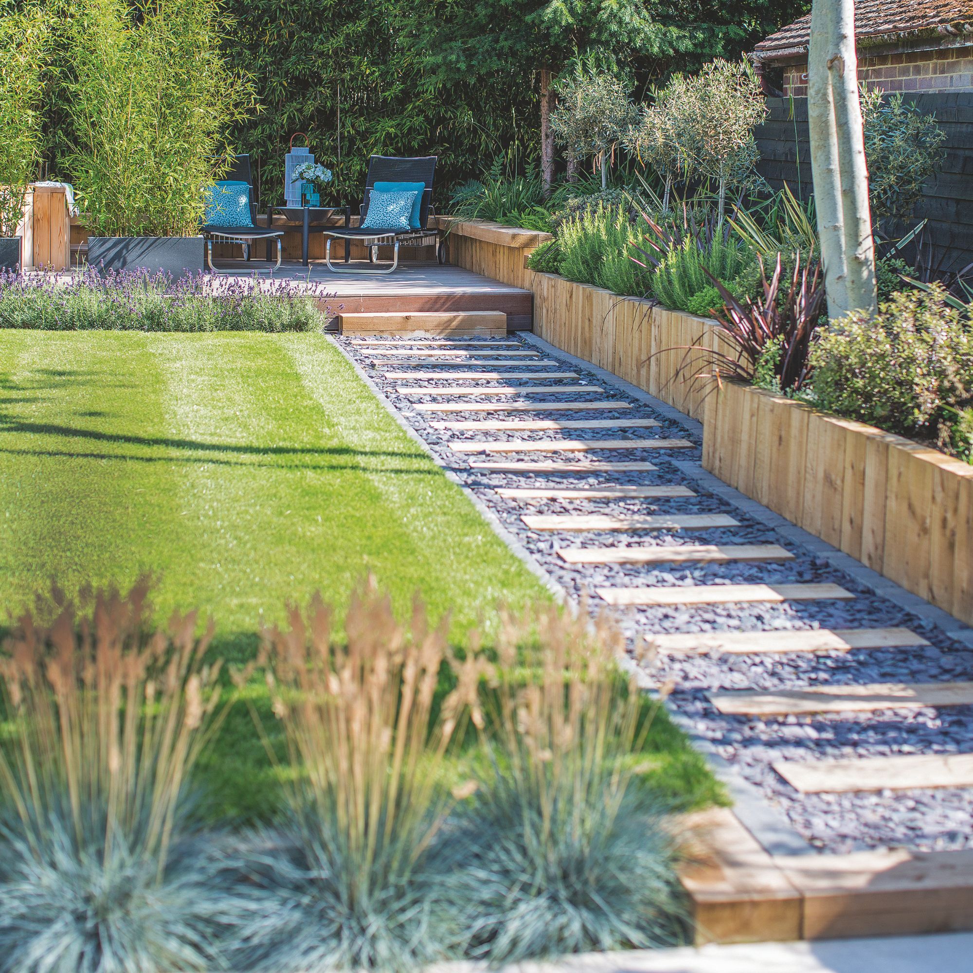 garden with striped lawn and a path next to it