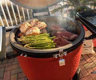 Grilling steaks, asparagus, and lobster tails in a Kamado Joe