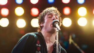 Jeremy Allen White singing into a microphone in Springsteen: Deliver Me from Nowhere