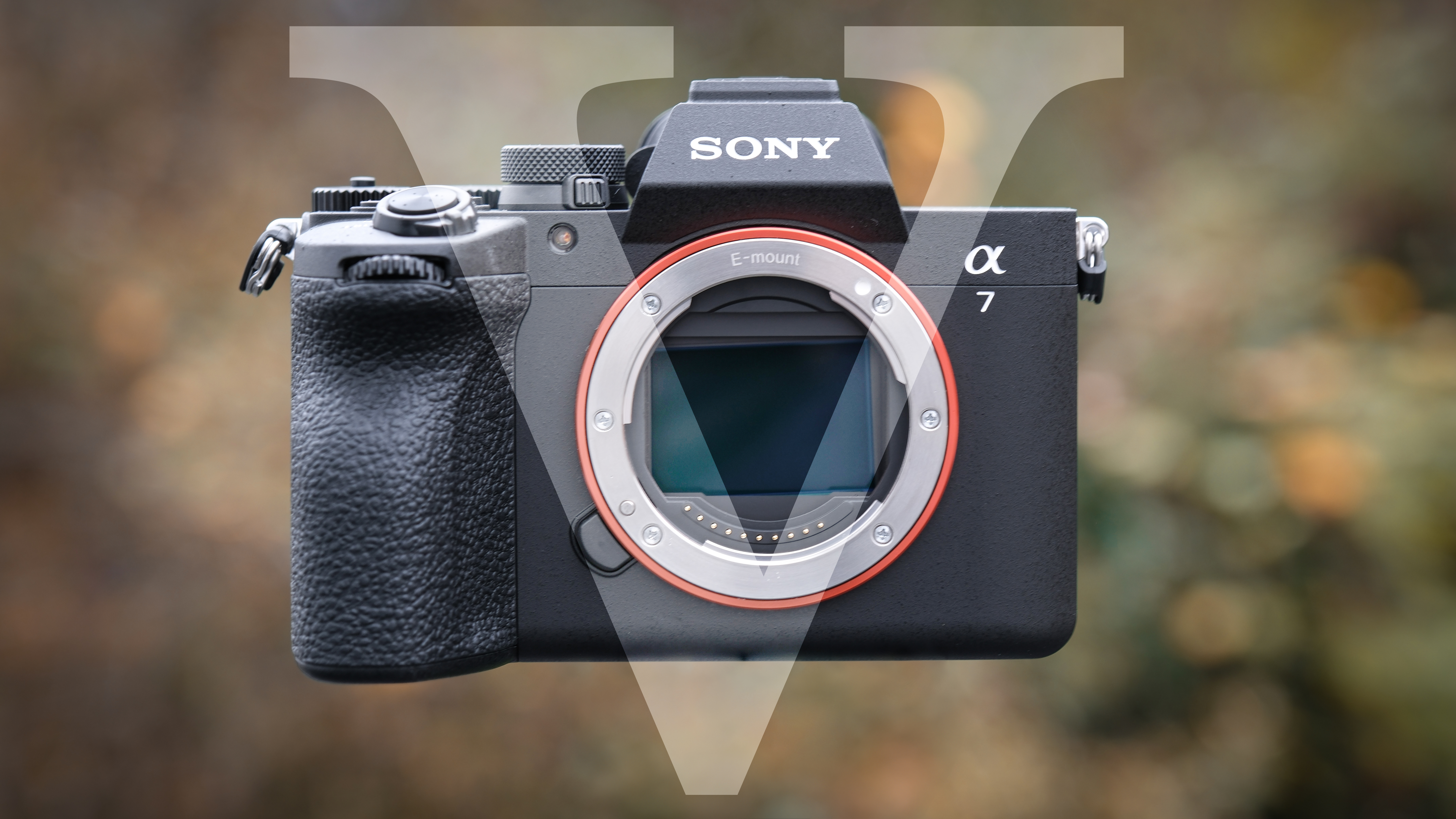 Sony A7 V against a green outdoor backdrop, with a &quot;V&quot; symbol