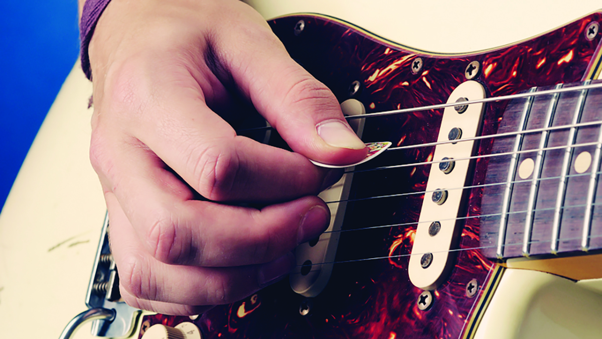 Player holding a guitar pick