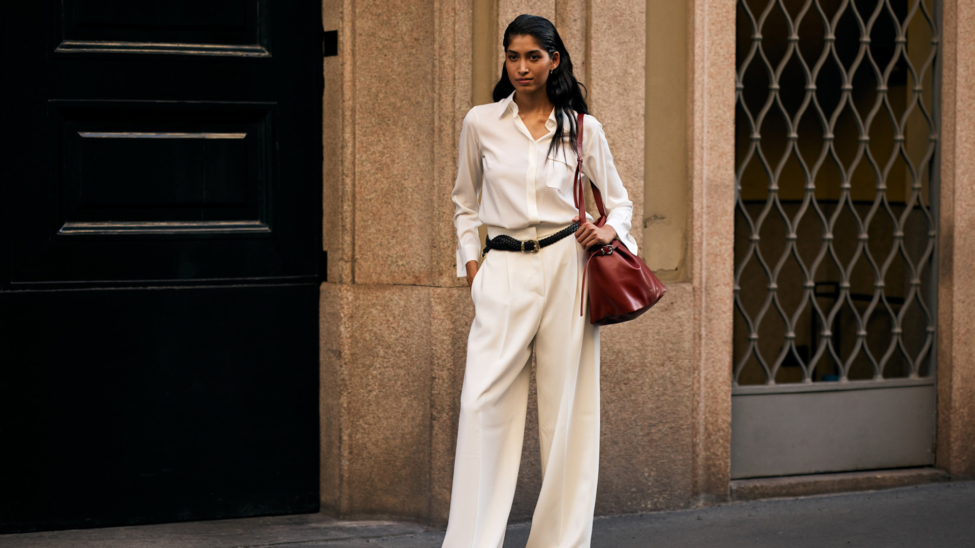 woman standing on the sidewalk in an all-white outfit