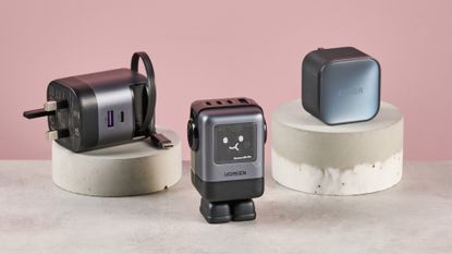 Anker 45W charger, UGreen Uno Charger 100W, and UGreen charger with retractable cable on pink background