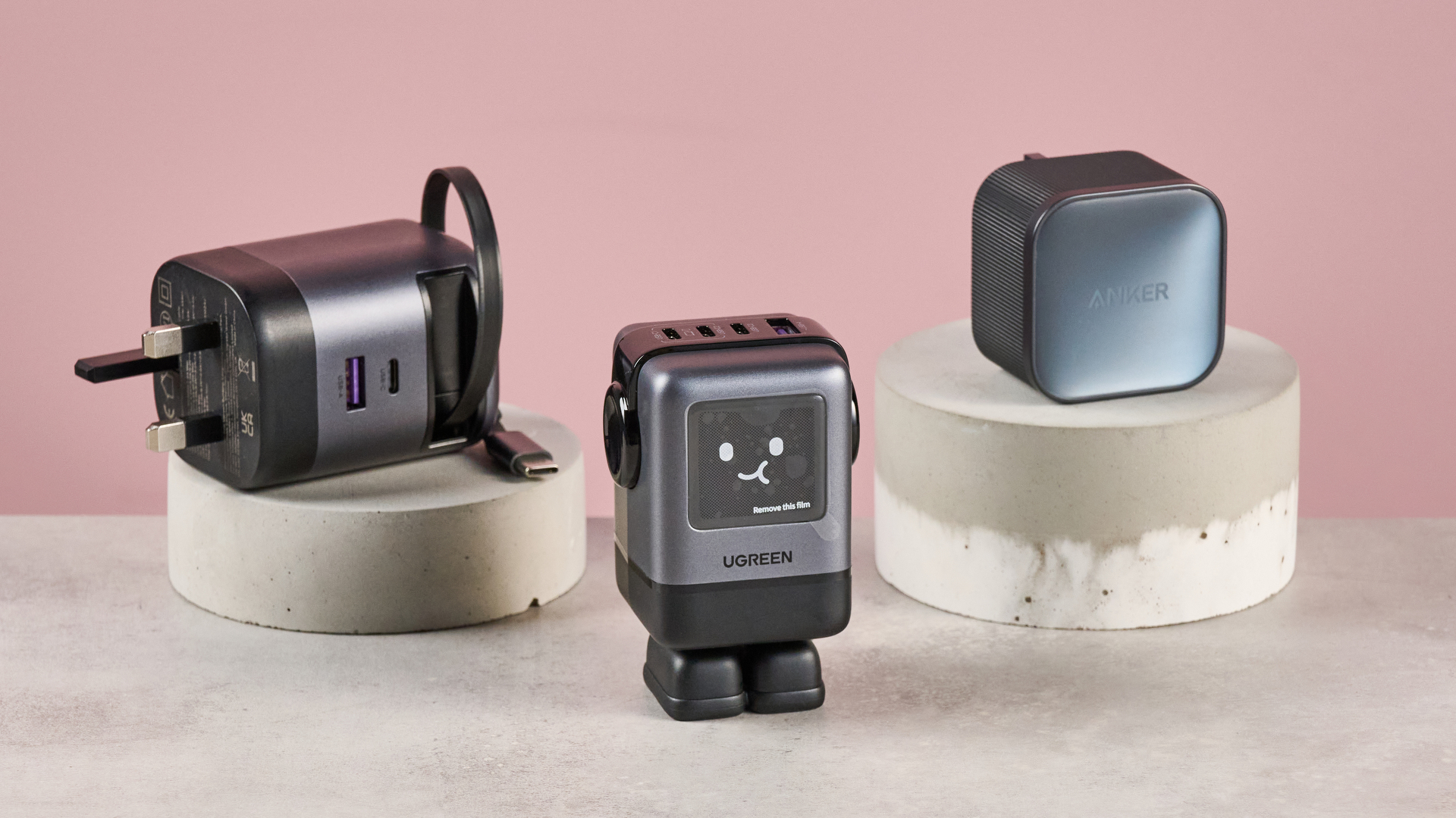 Anker 45W charger, UGreen Uno Charger 100W, and UGreen charger with retractable cable on pink background