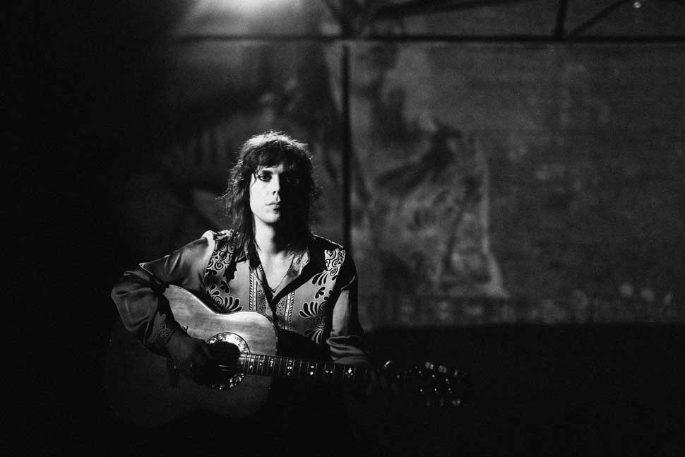 Luke Spiller playing an acoustic guitar