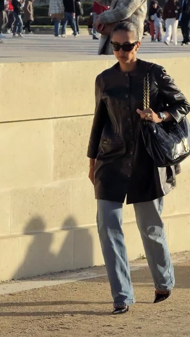 Photo of influencer wearing black leather collarless jacket.