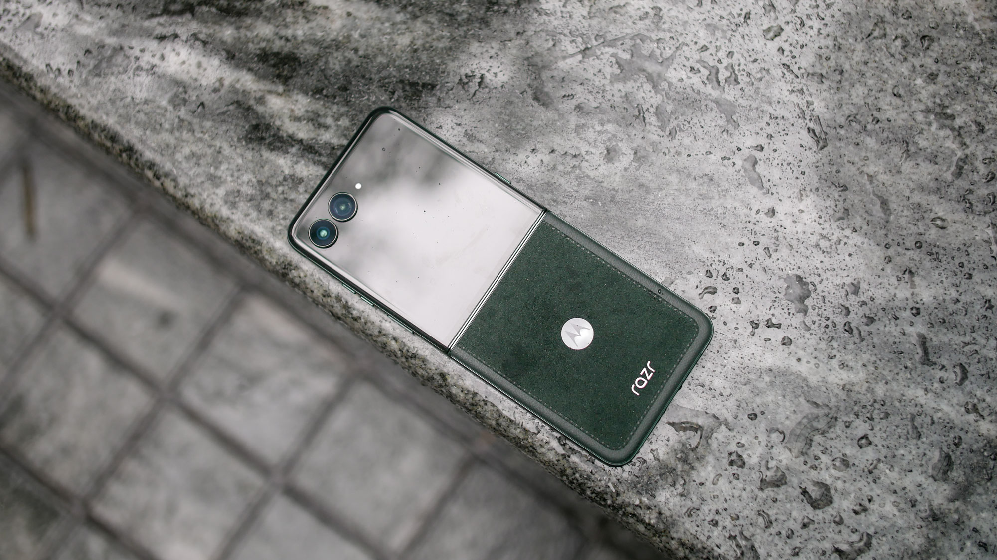Motorola Razr Ultra 2025 on top of marble surface showing Alcantara back.