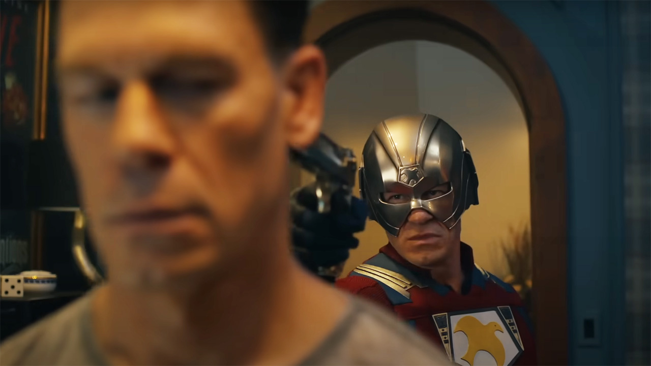 John Cena's Chris Smith being held at gunpoint by a different Chris Smith in Peacemaker season 2
