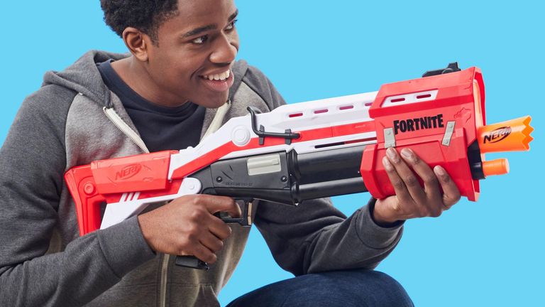 Best Nerf gun 2022, image shows boy holding a Nerf gun with blue background