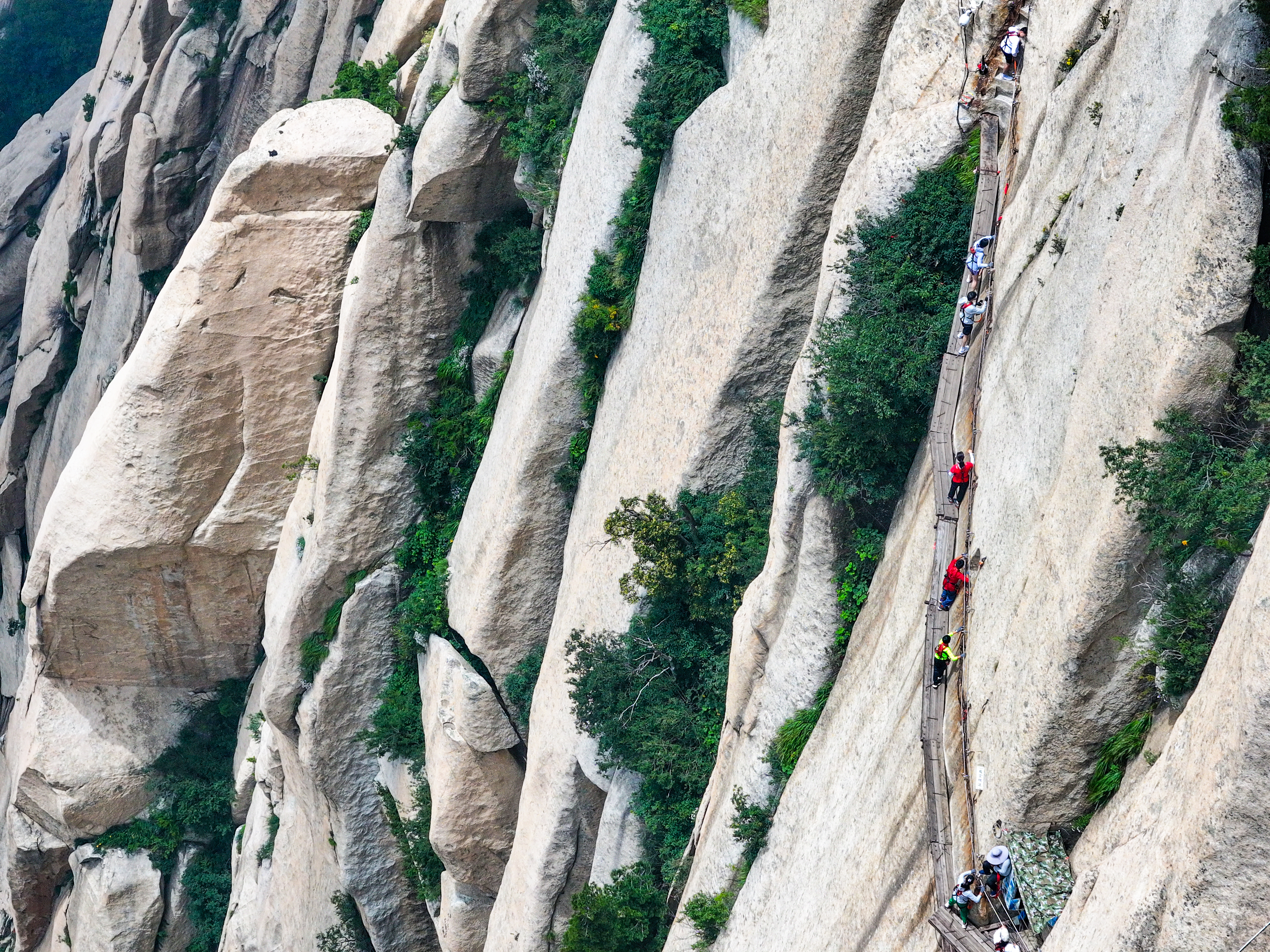 Climbers make their way up the Mount Huashan Plank Walk in China