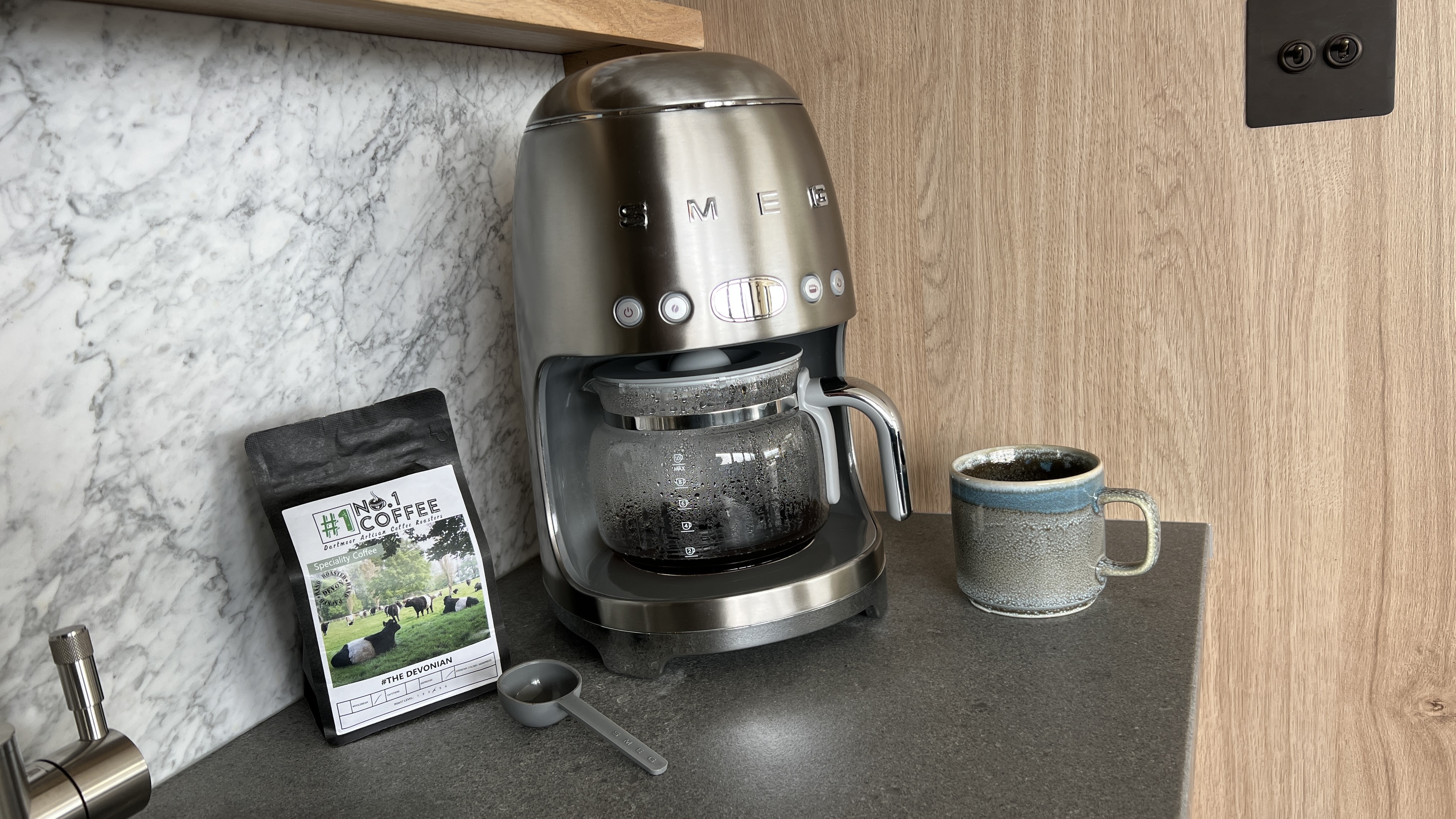 Smeg coffee machine with coffee and mug