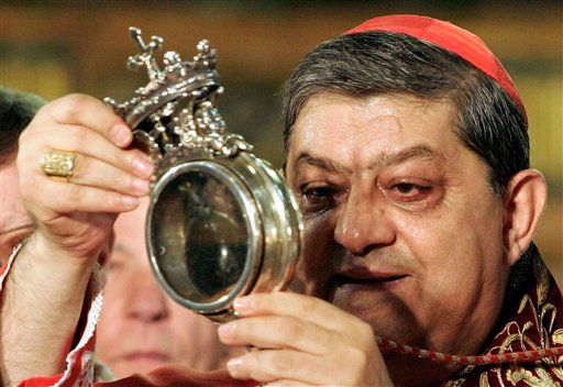 Cardinal Crescenzio Sepe holds the relic containing San Gennaro liquified blood