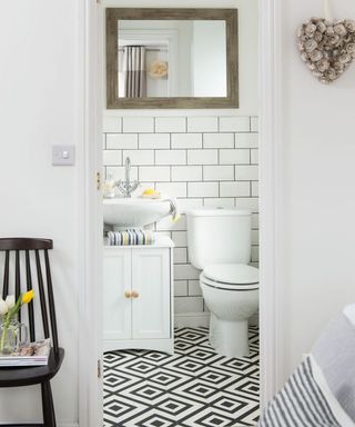 a toilet with white wall and zebra print tile flooring
