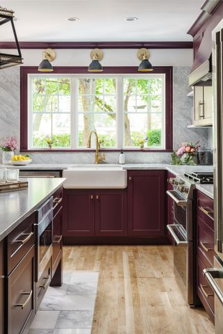 Burgundy Shaker-style kitchen with white marble countertop and backsplash