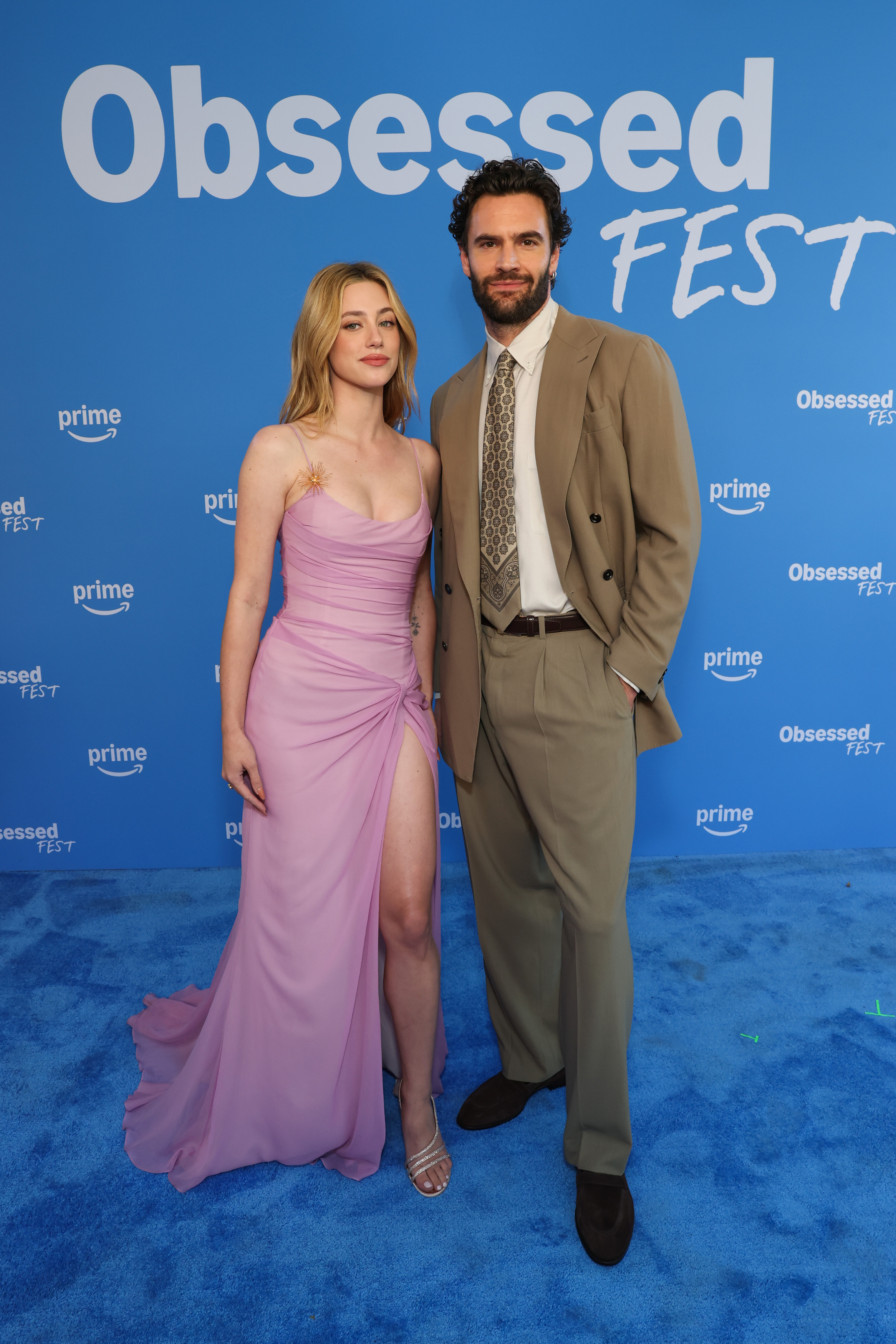 Lili Reinhart attends Obsessed Fest wearing a light pink sheer custom gown from Cult Gaia with silver strappy sandals