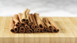 sticks of cinnamon on wooden board