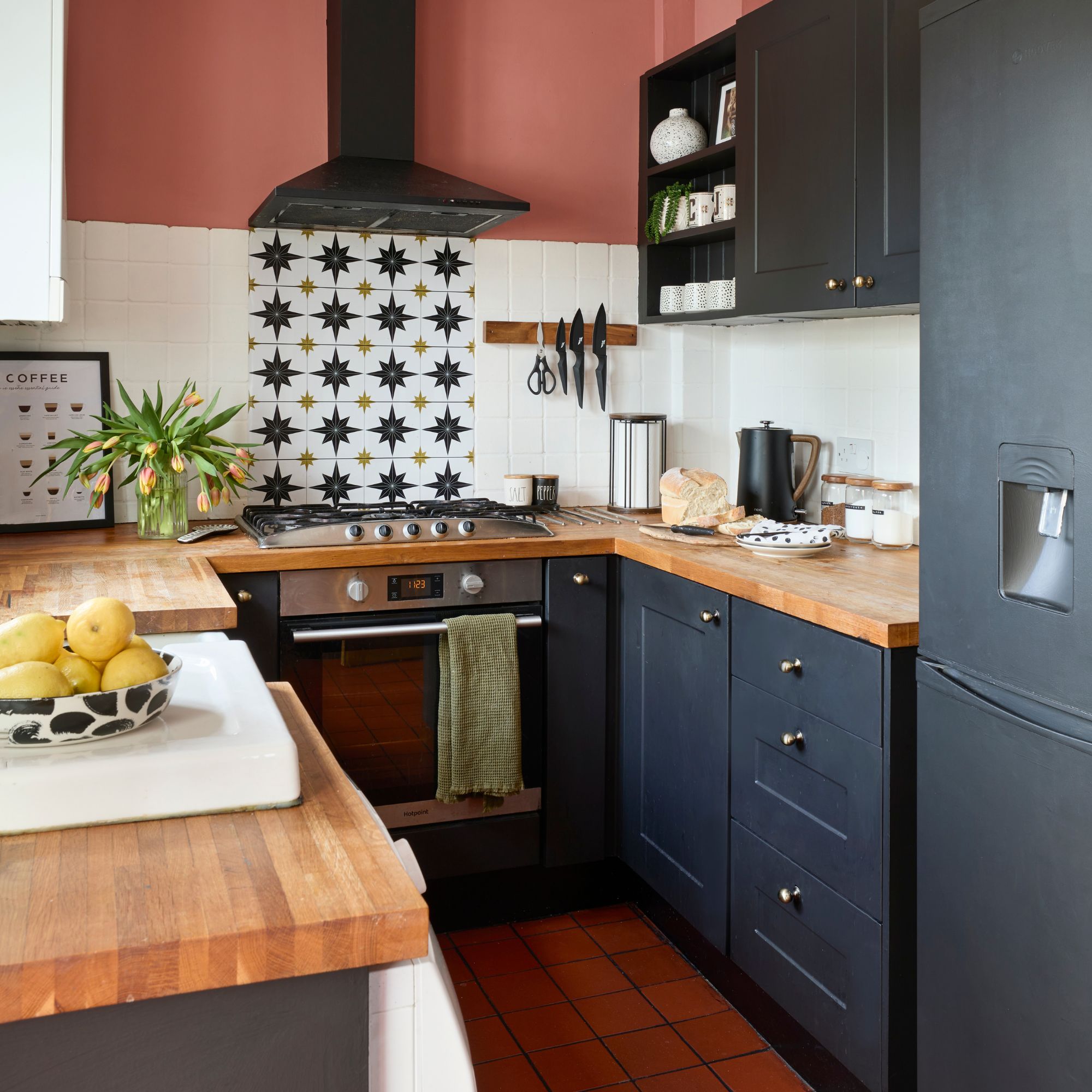 White and red painted galley kitchen with dark blue cabinets