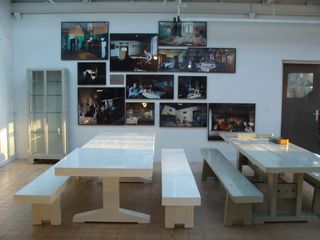 Eating area with benches and a selection of images on the wall