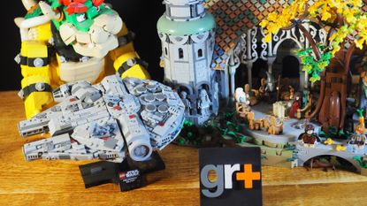 Lego Mighty Bowser, Millennium Falcon, and Rivendell on a wooden table behind a GamesRadar+ logo