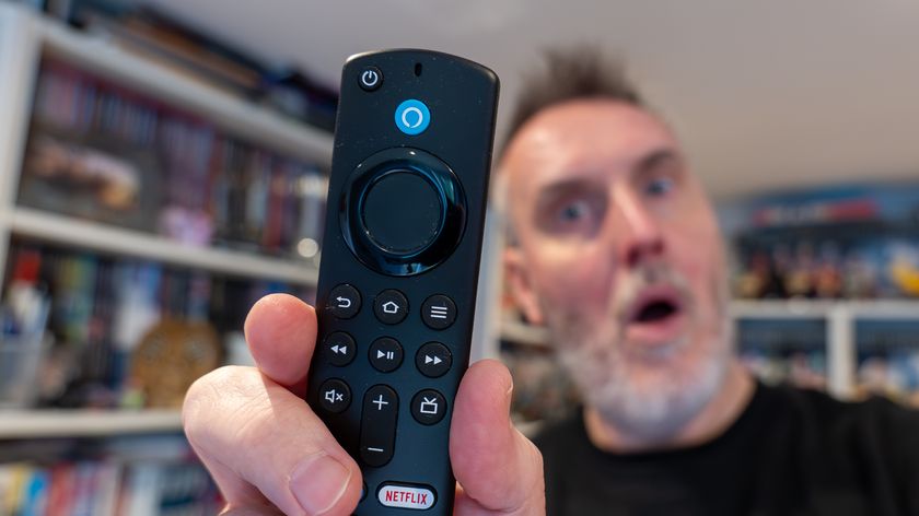 Amazon Fire TV Stick remote held by Rik Henderson in a home setting