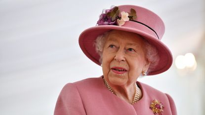 Queen Elizabeth pictured in a pink hat and coat