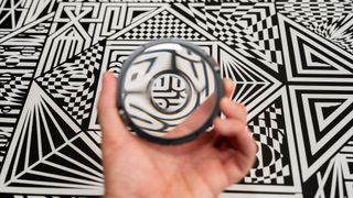 The PolarPro Warp Filter against a black and white geometric background