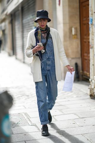 woman wearing overalls and sweater