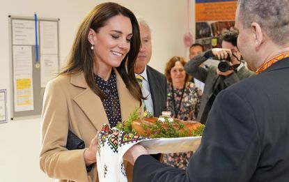 Kate Middleton remixes camel and navy for nursing home visit