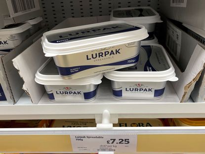 Tubs of Lurpak butter displayed on a supermarket shelf