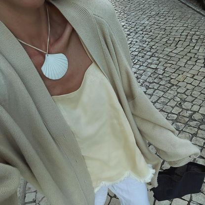 anouk yve wears a cord pendant necklace