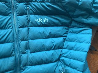 Water beads on Rab Infinity Microlight jacket showing it's water resistance