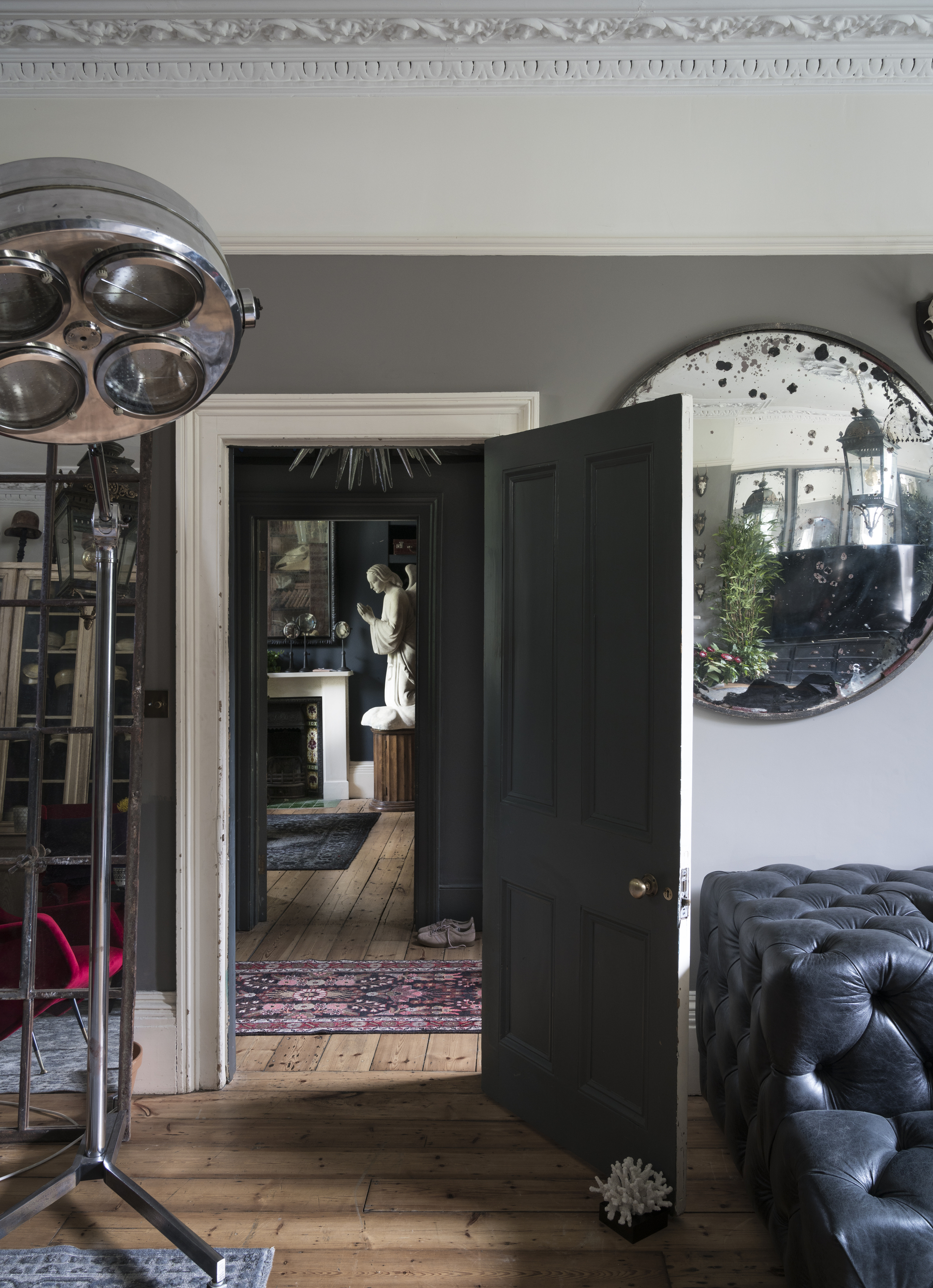 View through a black doorway from one living room across the hall to another