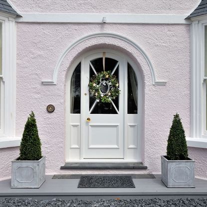 white house with front door and christmas tree