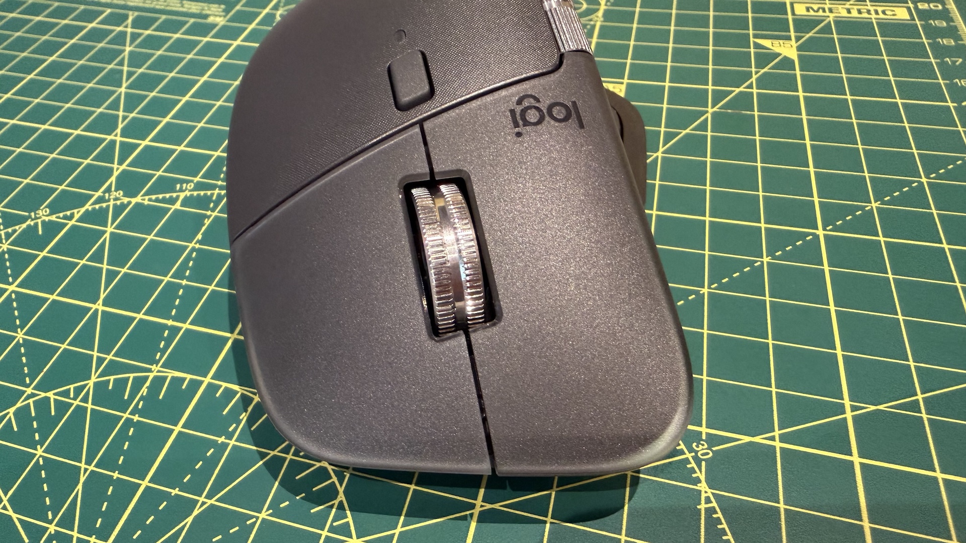 The Logitech MX Master 4 mouse on a graphing grid