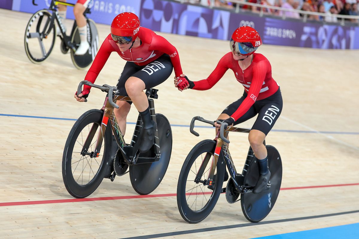 Picture by Alex Whitehead/SWpix.com - 09/08/2024 - Paris 2024 Olympic Games - Track Cycling - National Velodrome, Saint-Quentin-en-Yvelines, France - Women's Madison Final - Amalie Dideriksen (Denmark) and Julie Norman Leth (Denmark) performing a handsling